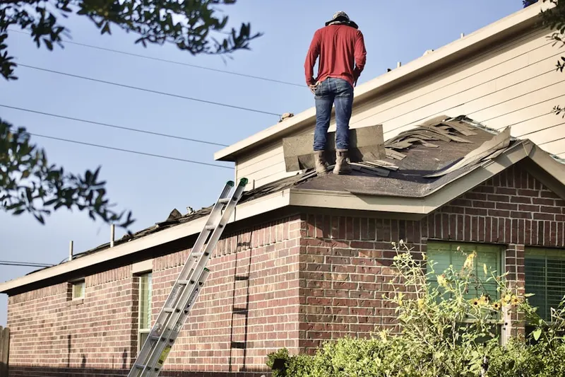 Professional roofer working on a residential roof in Blair